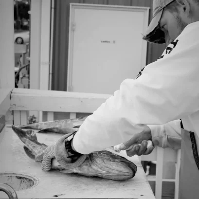 Captain Erich Jaeger filleting fish during his charter days