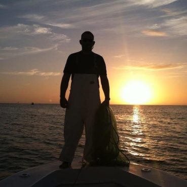 Captain Erich Jaeger with a cast net from his fishing charter days