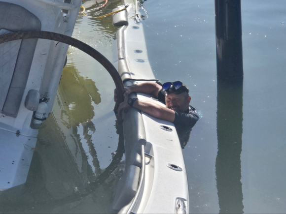 Captain Erich Jaeger working in the water during a boat salvage